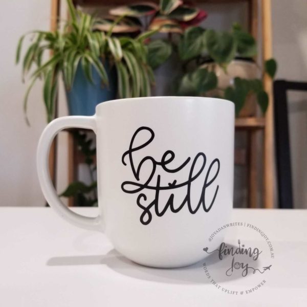 "Be still" custom, hand-drawn white stone mug with black writing