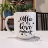 White stone mug with black calligraphy that says "coffee is my love language"